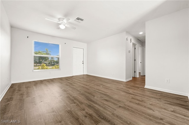 spare room featuring ceiling fan and dark hardwood / wood-style flooring