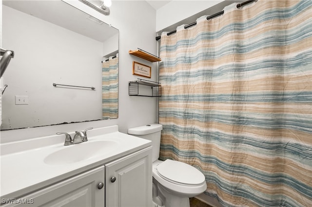 bathroom with vanity, toilet, and curtained shower