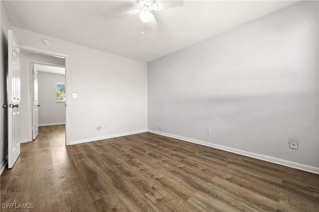 spare room with ceiling fan and dark hardwood / wood-style flooring