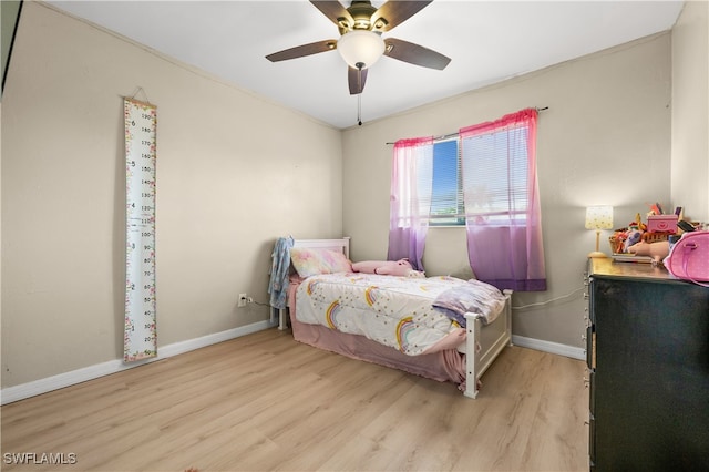 bedroom with ceiling fan and light hardwood / wood-style floors