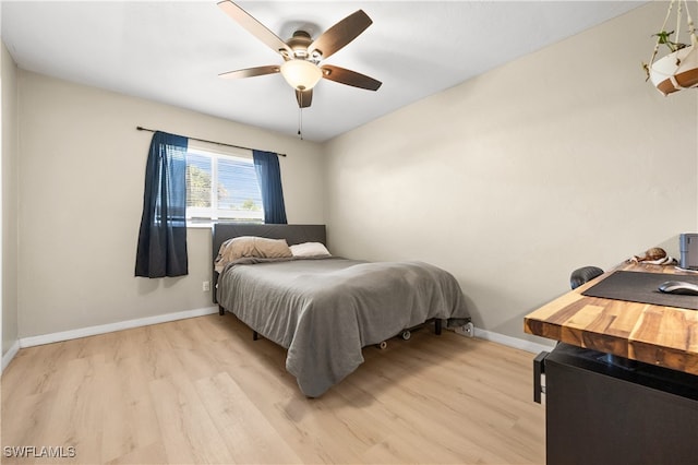 bedroom featuring ceiling fan and light hardwood / wood-style flooring