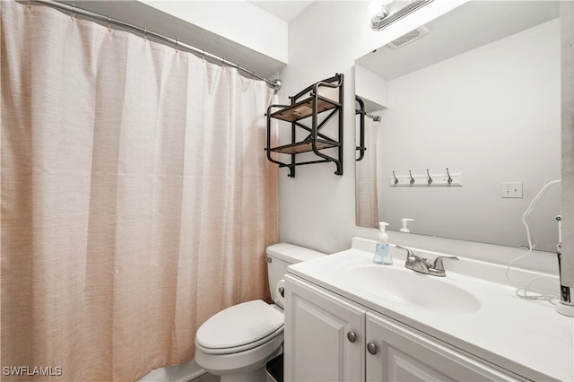 bathroom featuring vanity, toilet, and a shower with shower curtain