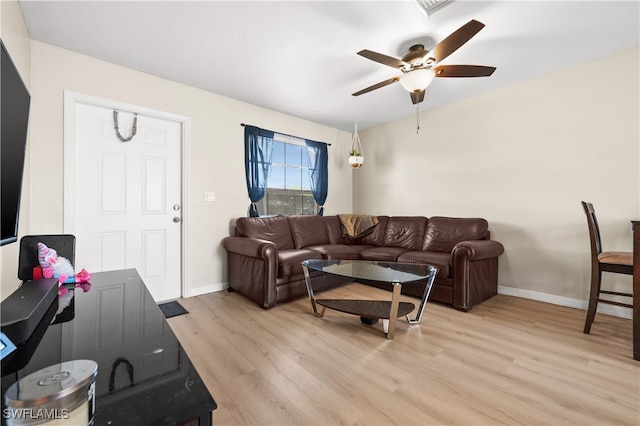 living room featuring light hardwood / wood-style flooring and ceiling fan