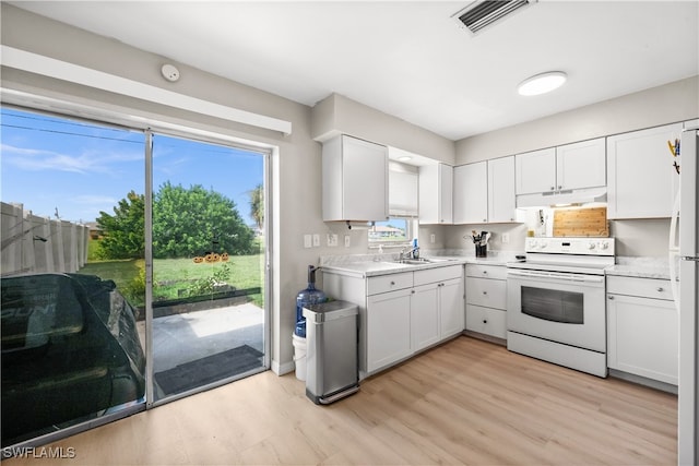 kitchen with white electric range, white cabinets, sink, and light hardwood / wood-style flooring