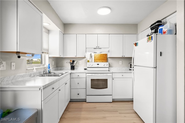 kitchen with light wood-type flooring, white cabinets, white appliances, and sink