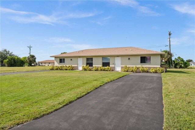 ranch-style home with a front yard