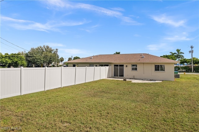 back of house with a yard, a patio area, and central AC unit