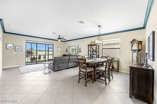 tiled dining space with ornamental molding and ceiling fan