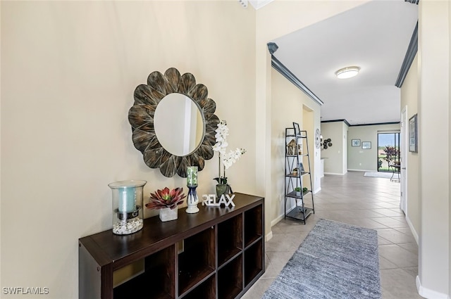 hall with light tile patterned flooring and crown molding