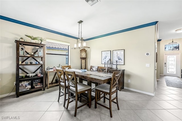 tiled dining space featuring crown molding