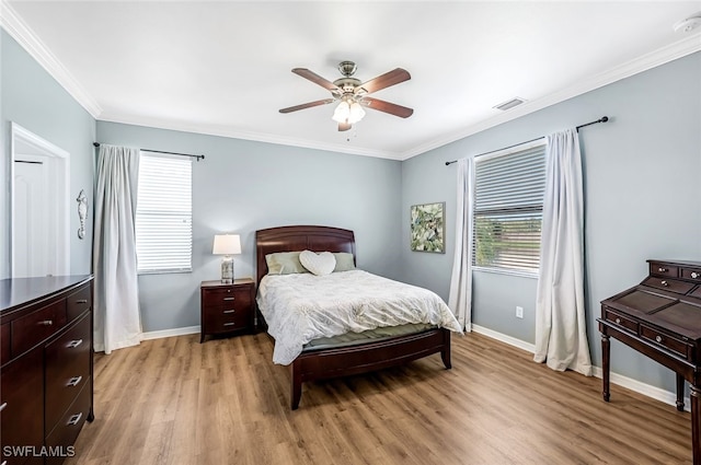 bedroom with light wood-type flooring, ceiling fan, and crown molding