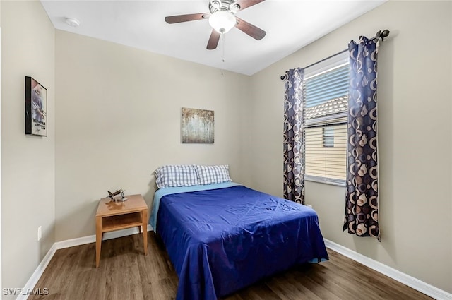 bedroom with ceiling fan and dark hardwood / wood-style flooring