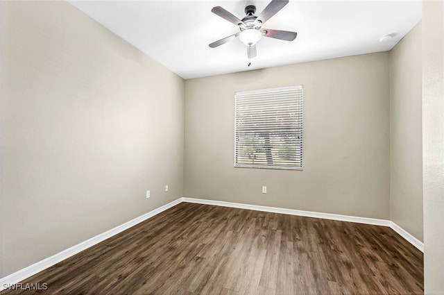 spare room with ceiling fan and dark hardwood / wood-style floors