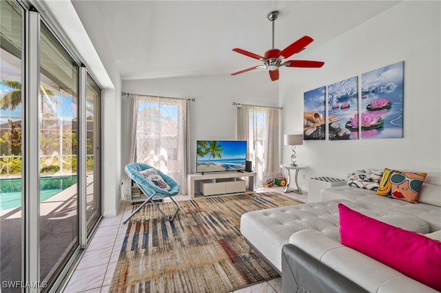 living room featuring lofted ceiling, ceiling fan, and light tile patterned floors