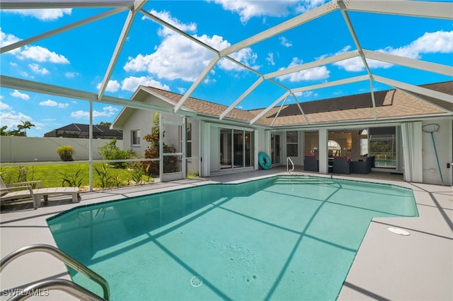 view of swimming pool with a patio and a lanai