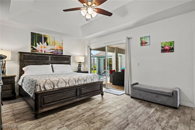 bedroom with light hardwood / wood-style flooring, access to exterior, and ceiling fan