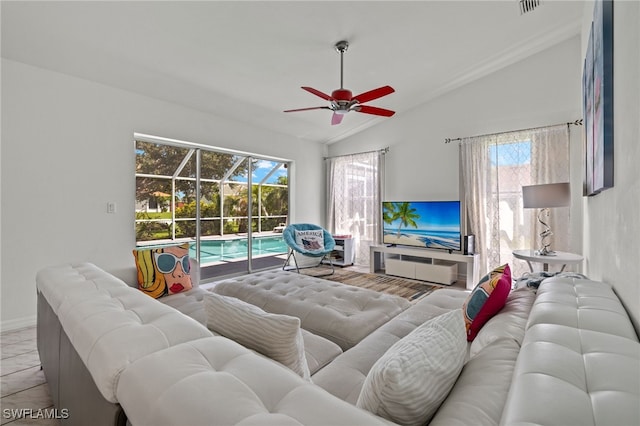 living room with light wood-type flooring, vaulted ceiling, and ceiling fan