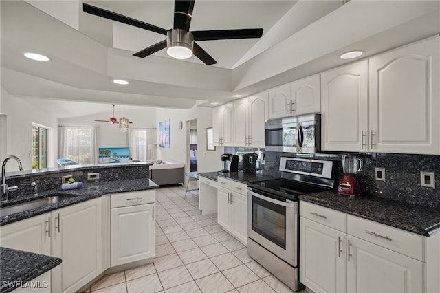 kitchen featuring white cabinetry, vaulted ceiling, sink, ceiling fan, and appliances with stainless steel finishes