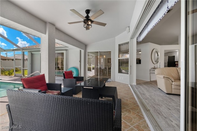 sunroom featuring lofted ceiling and ceiling fan