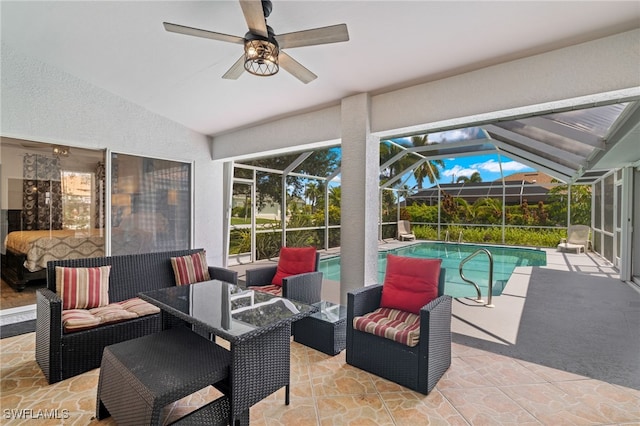 view of patio / terrace featuring outdoor lounge area, ceiling fan, and glass enclosure