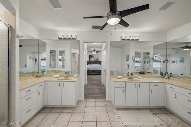 bathroom featuring vanity, hardwood / wood-style floors, walk in shower, and ceiling fan