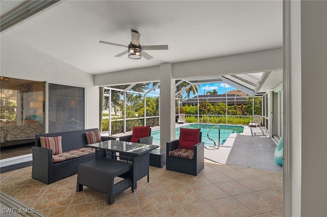 view of patio / terrace with an outdoor living space, ceiling fan, and a lanai