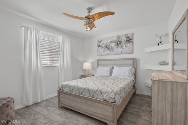 bedroom with ceiling fan and light hardwood / wood-style floors