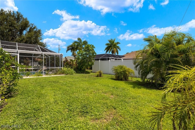 view of yard featuring glass enclosure