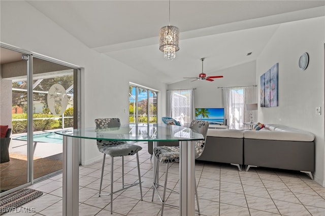 tiled dining area featuring lofted ceiling and ceiling fan