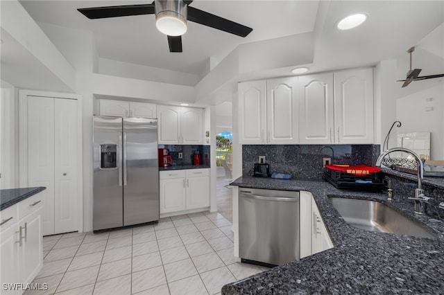 kitchen featuring backsplash, stainless steel appliances, sink, ceiling fan, and white cabinets