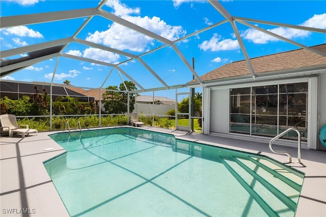 view of swimming pool with a lanai and a patio area