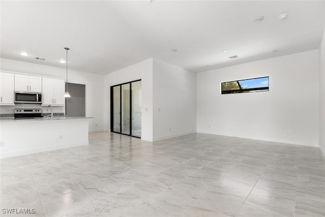 unfurnished living room with sink