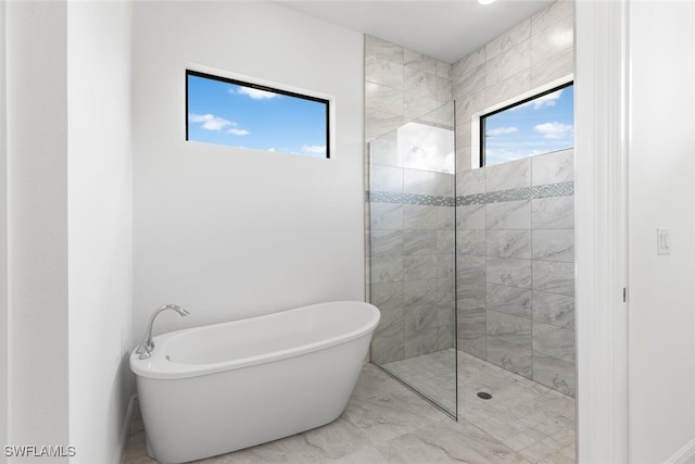 bathroom featuring separate shower and tub