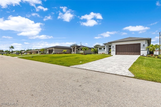 view of front of home featuring a front lawn and a garage