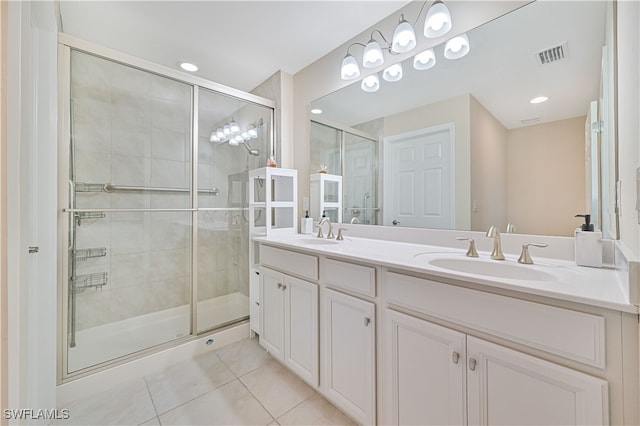 bathroom featuring vanity, a shower with shower door, and tile patterned floors