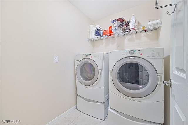 laundry area featuring separate washer and dryer and light tile patterned floors