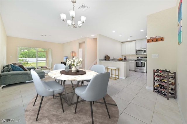 dining space featuring light tile patterned floors and an inviting chandelier