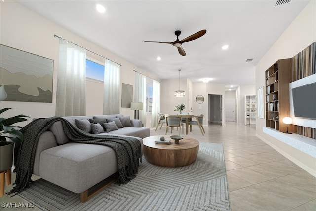 living room with ceiling fan and light tile patterned floors