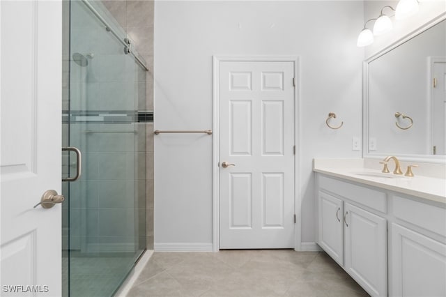 bathroom with tile patterned floors, a shower with shower door, and vanity