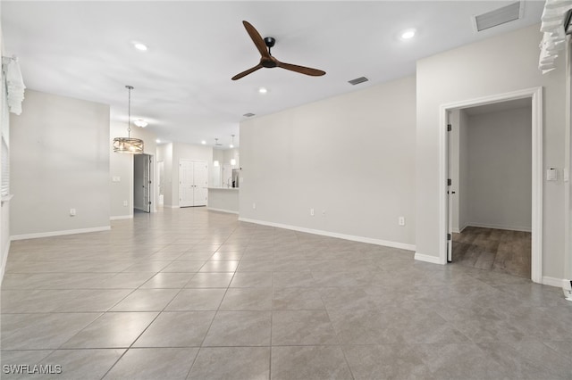 unfurnished living room featuring light tile patterned flooring and ceiling fan