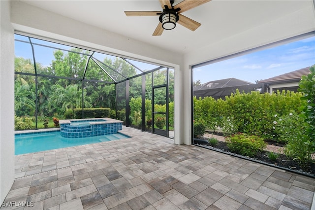 view of pool featuring an in ground hot tub, ceiling fan, glass enclosure, and a patio