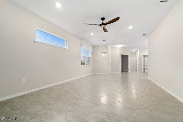 spare room with light tile patterned floors and ceiling fan