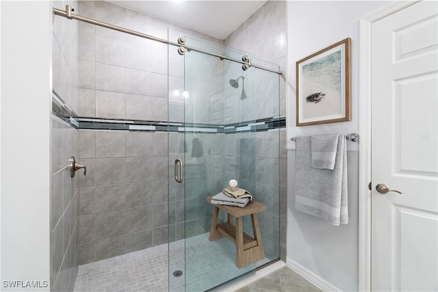 bathroom featuring tile patterned floors and a shower with shower door