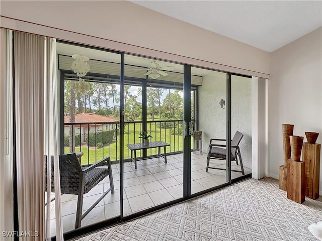 doorway to outside featuring a ceiling fan and carpet flooring