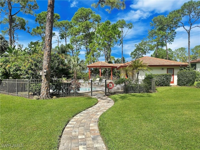 view of yard featuring a gazebo, fence, and a fenced in pool