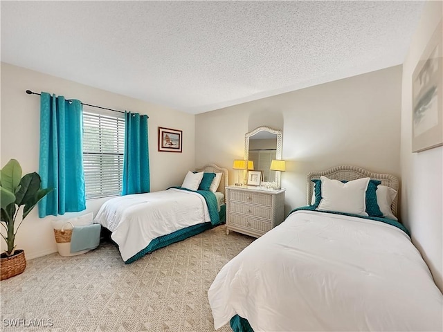 bedroom featuring a textured ceiling and carpet