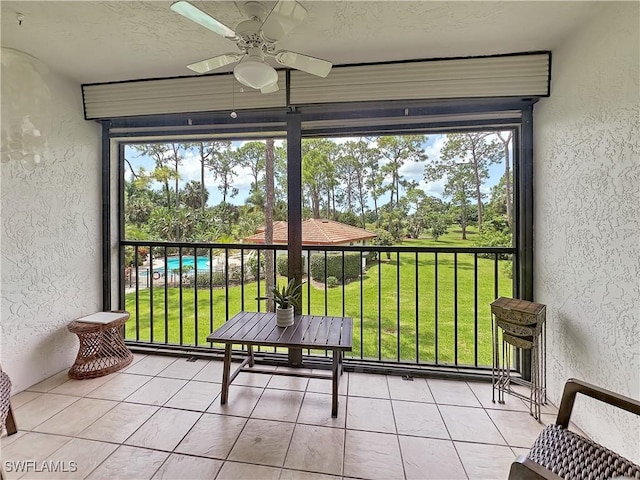 sunroom featuring a ceiling fan