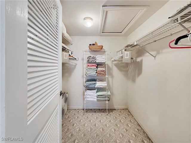 spacious closet featuring attic access