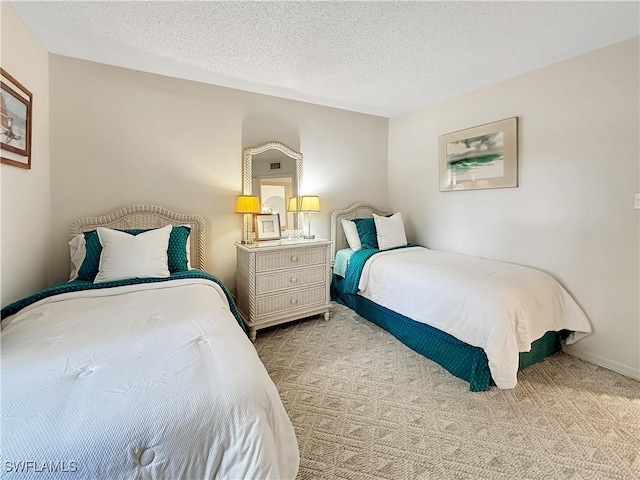 carpeted bedroom featuring a textured ceiling