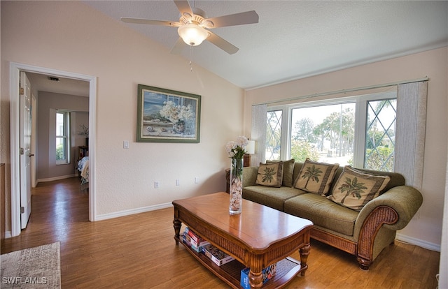 living room with hardwood / wood-style flooring, lofted ceiling, a healthy amount of sunlight, and ceiling fan